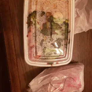 a plastic container with broccoli in it