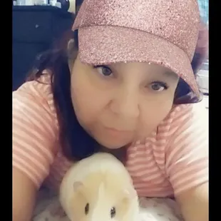  a girl with a pink hat and a hamster