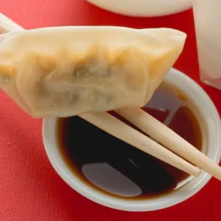 a dumpling with chopsticks