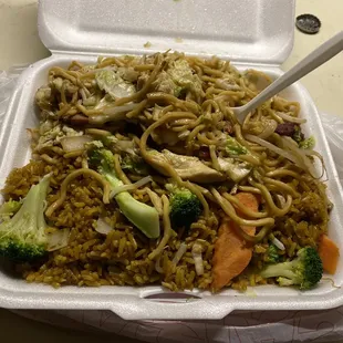 a takeout container with noodles and vegetables