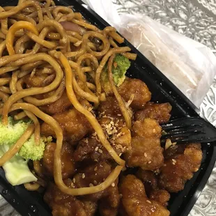 noodles and broccoli in a plastic container
