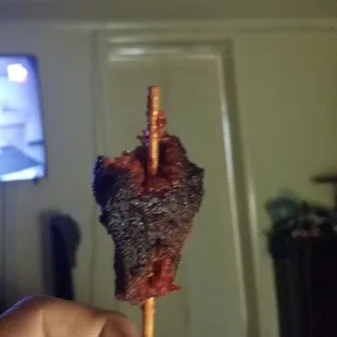 The beef on a stick wasn't fully cooked. Good thing I tore it off instead of biting it!
