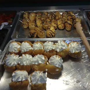 a tray of pastries and a tray of donuts