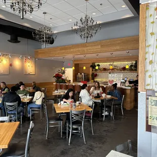 people sitting at tables in a restaurant