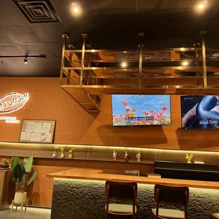 a restaurant with a bar and televisions