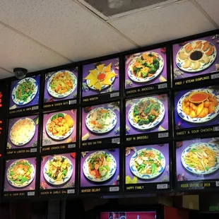 a large menu board with asian food on it