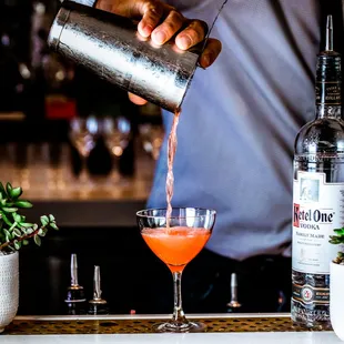 a bartender pouring a drink