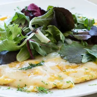 an omelet with greens on top