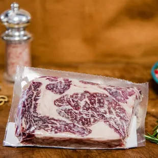 a piece of beef wrapped in plastic