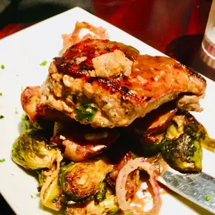 Pork chop with smashed potatoes with Brussel sprouts with gravy.