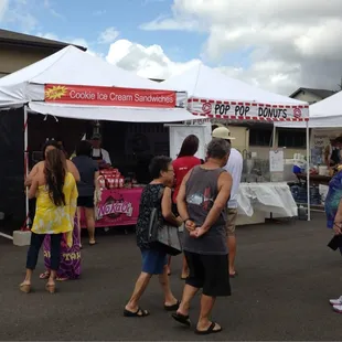  crowd of people standing under tents