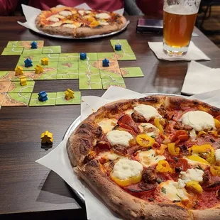 two pizzas on a table