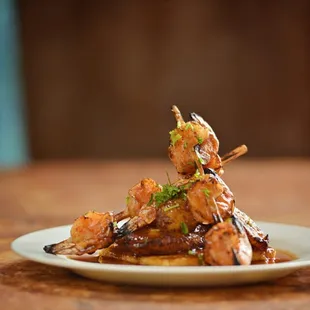 Shrimp Alambres sugar cane  skewers served on our own masa cake with tamarind glaze.