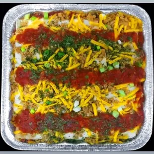 Vegan Mexican lasagna made with our very own vegan Mexican crumbles, scallions, vegan cheese, and Mexican authentic sauce