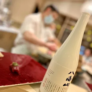 a bottle of sake sitting on a table