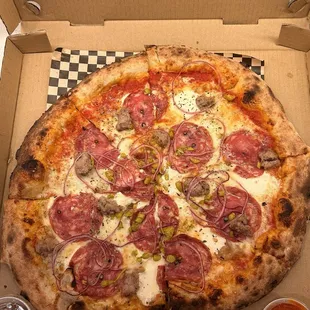 Salami Supremo with sausage and hot honey on the side.