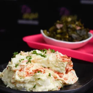 a plate of mashed potatoes and greens