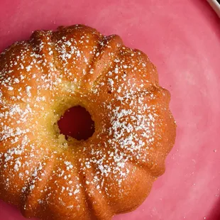 a donut on a pink plate