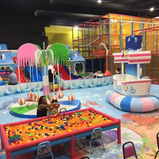 Toddler Area with ball pit, sensory stimulating games, slides, kids videos and work tables!