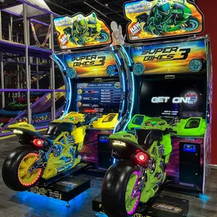 two arcade machines with neon lights