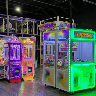 two arcade machines with neon lights