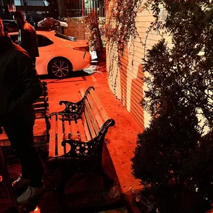 a man standing next to a bench