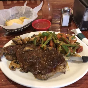 18 ounce ribeye with  sautéed mushrooms, grilled onions,tomatoes and peppers.