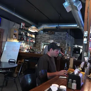 two men sitting at a bar