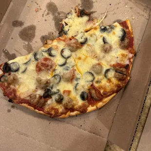 Thin crust with sausage, pepperoni, onion, and black olive.