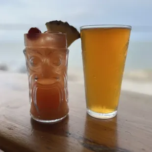 a tiki and a glass of beer