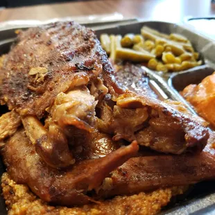 a plate of meat and sides