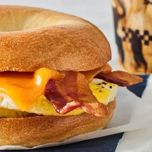 a breakfast sandwich with eggs and bacon
