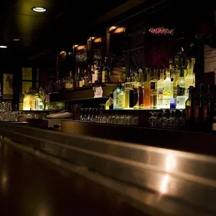 a bar with many bottles of alcohol