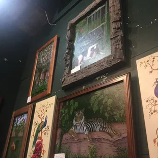 Paintings by local artists on the wall in the restaurant