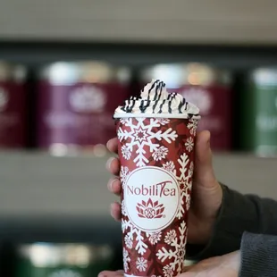 a person holding a cup of coffee