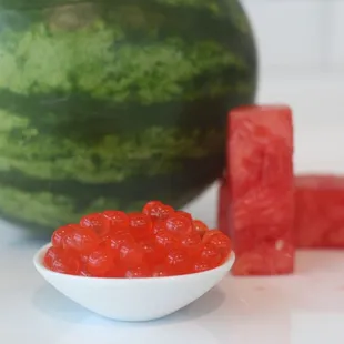 a bowl of watermelon and cubes of watermelon
