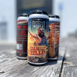 three cans of beer on a wooden table