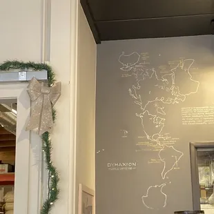 Map mural depicting origins of various coffee beans, along with a little Christmas decor.