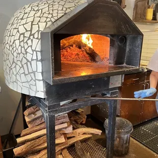 a man putting wood in an oven