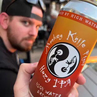 a man holding a can of beer