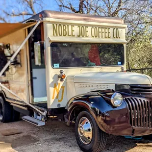a coffee truck parked in a field