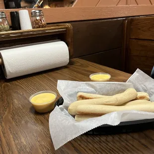 a basket of breadsticks on a table