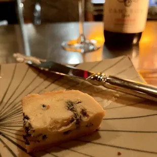 a piece of bread and a glass of wine
