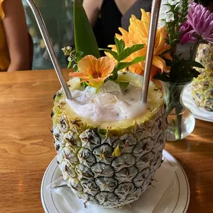 a pineapple drink with a straw in it