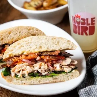traditional herb roasted chicken, hand-cut bacon, roasted tomatoes, pickled red onion, mixed greens, housemade garlic aioli &amp; warm ciabatta