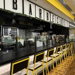 a bar with yellow bar stools