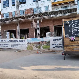a truck parked in front of a building under construction