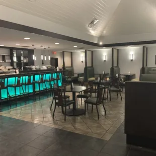 dining area with tables and booths when you first walk in (including bar)