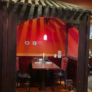 a dining area with a table and chairs