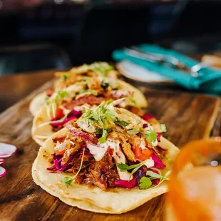 two tacos on a cutting board